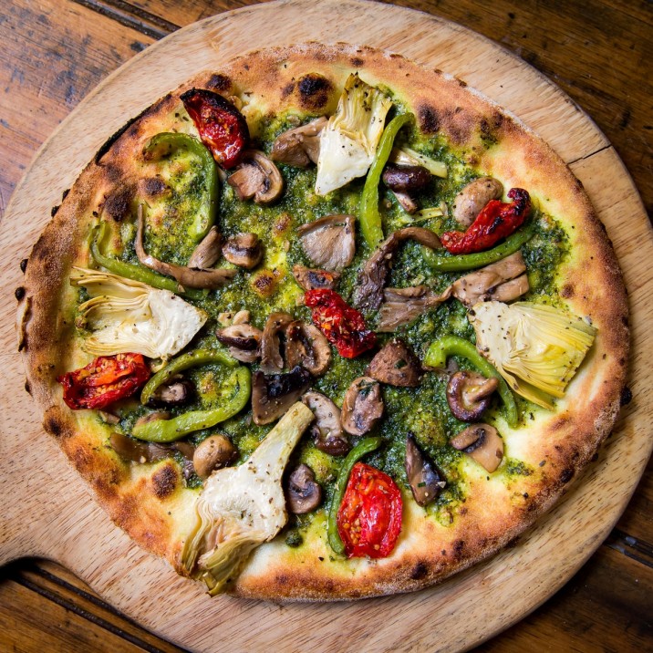 Pizza Verde Vitality: Green Pesto Base, Wild Mushrooms, Artichoke, Green Peppers, Sunblushed Tomatoes, Rocket