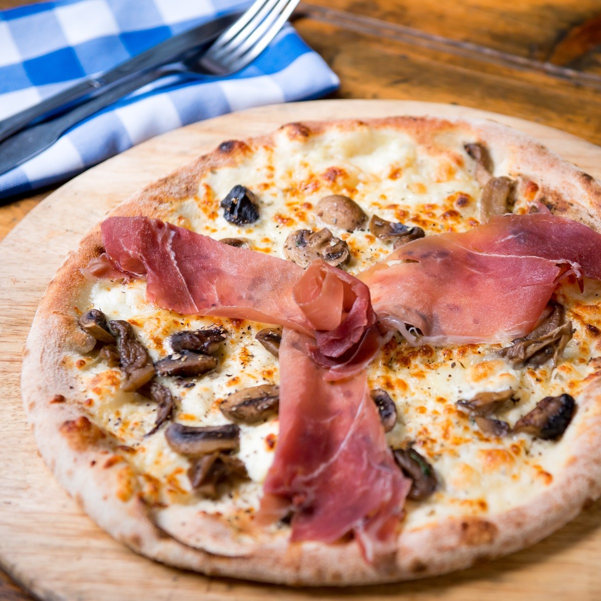 Pizza Roxanne: Wild Mushrooms, Goat Cheese, Creme Fraiche, Mozzarella and finished with Prosciutto