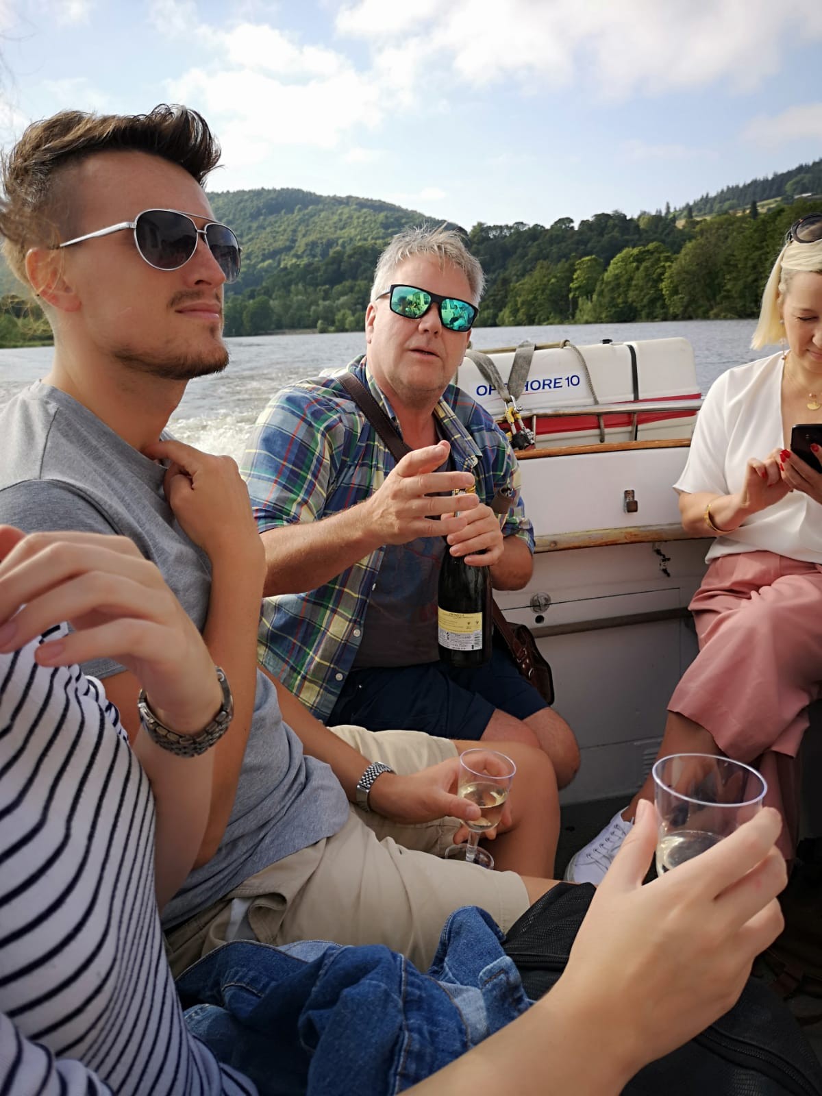 Team Small City popping the Prosecco whilst Boating on Tay