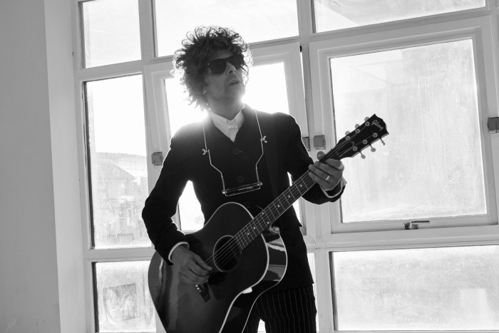 Bob Dylan - Press Shot b/w with guitar standing