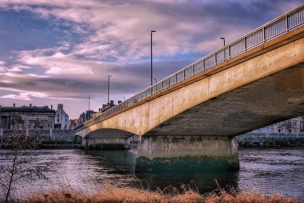 Perth's Queens Bridge looking towards Tay Street. Photo taken from below bridge at the edge of the River Tay looking up