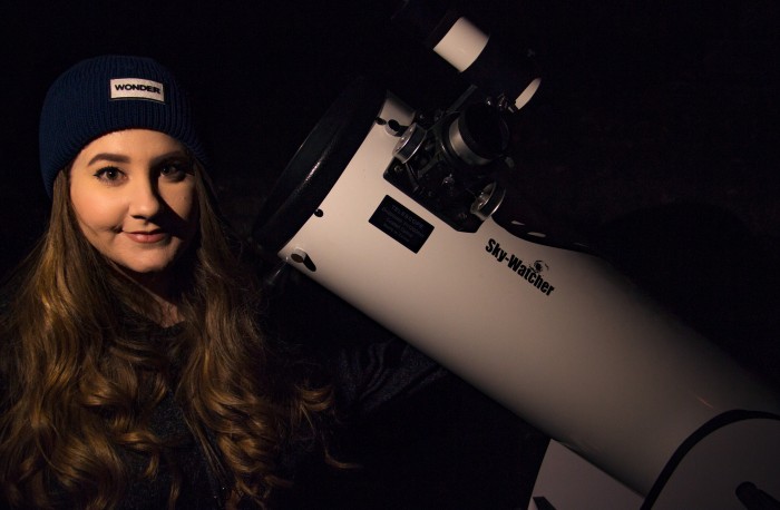With her trusty telescope!