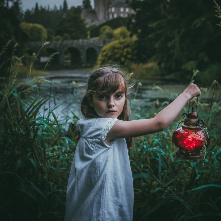 A young girl with an enchanted look in her eyes on the grounds of Drummond Castle in Perthshire.
