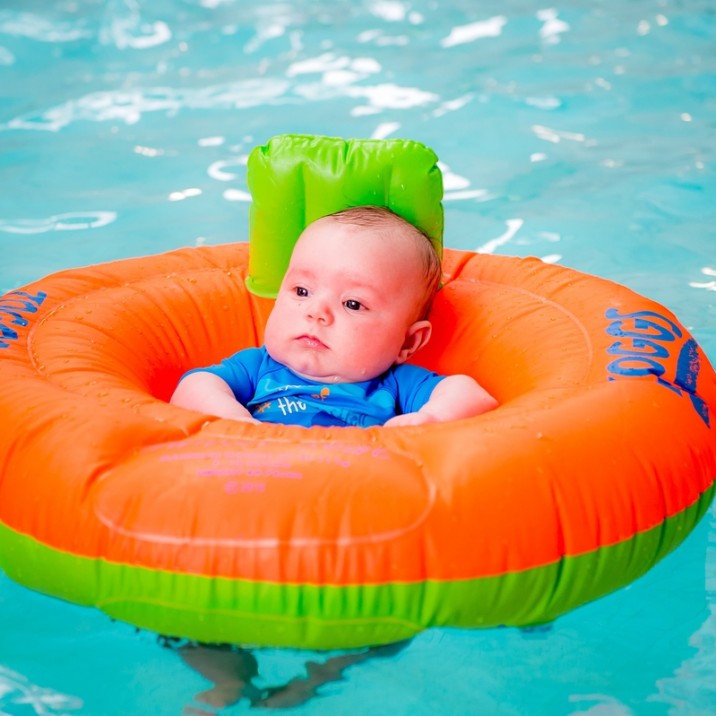 Baby in inflatable ring in the pool.