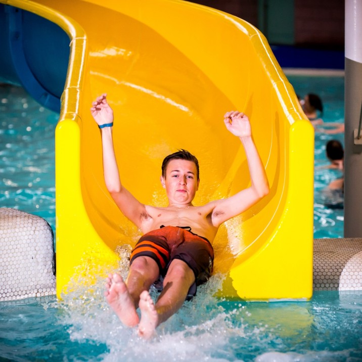 Boy sliding down the flume at Perth Leisure Pool.