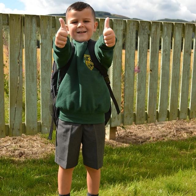 Ben puts his thumbs up in excitement as he starts his first day of Primary one at Dunbarney Primary, Perth