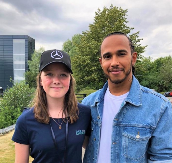 Young karting talent Chloe Grant poses for a photograph Formula 1 racing driver Lewis Hamilton.