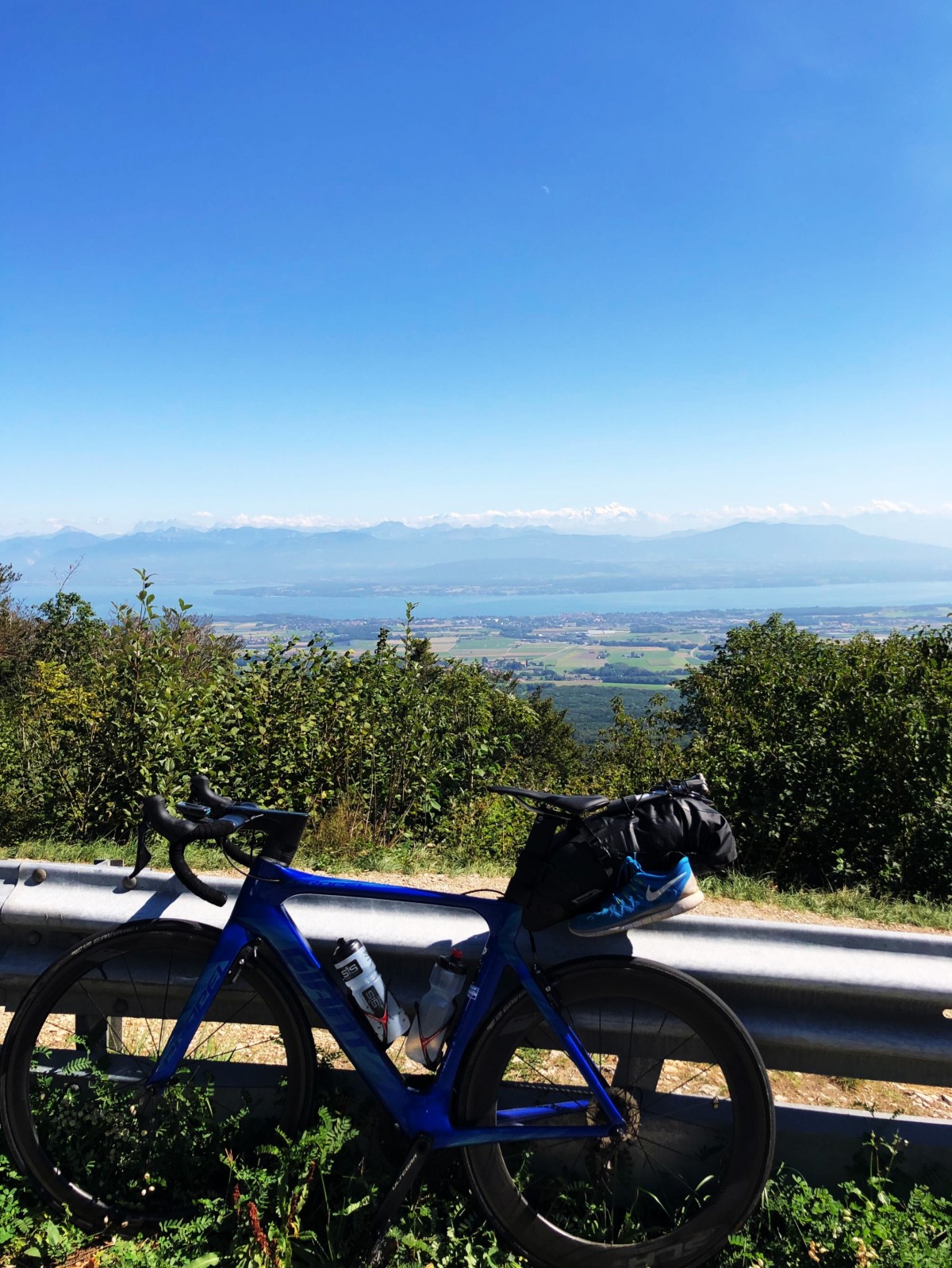 "my bike in front of Lake Geneva with the Alps in the backdrop - I was descending Saint Cergue at this moment. " - Olly